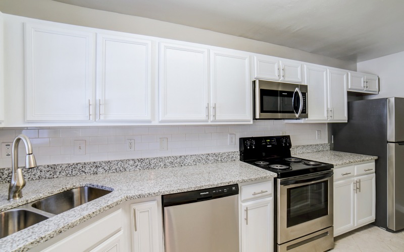 Apartment kitchen with white cabinets