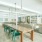 Clubhouse with large tables and green chairs