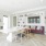 Work from home lounge with table, tv, and built in shelves filled with decor