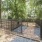 Fenced in dog park surrounded by trees